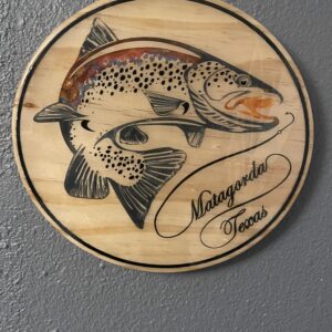 A fish print engraved on a wooden circle