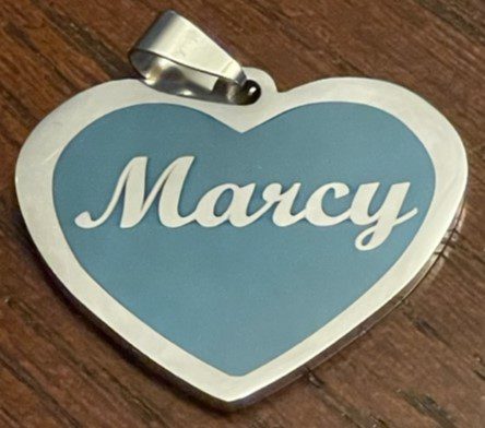 A Marcy text on a heart pendant