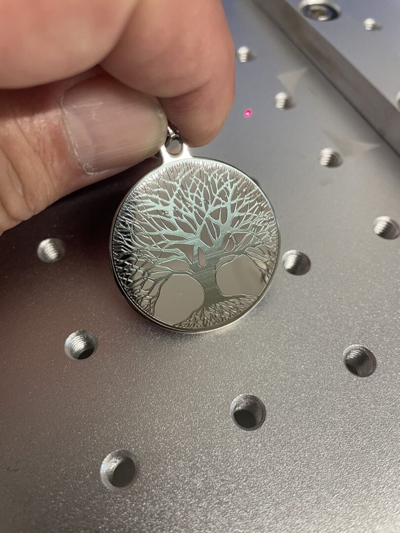 A leafless tree engraved on a pendant